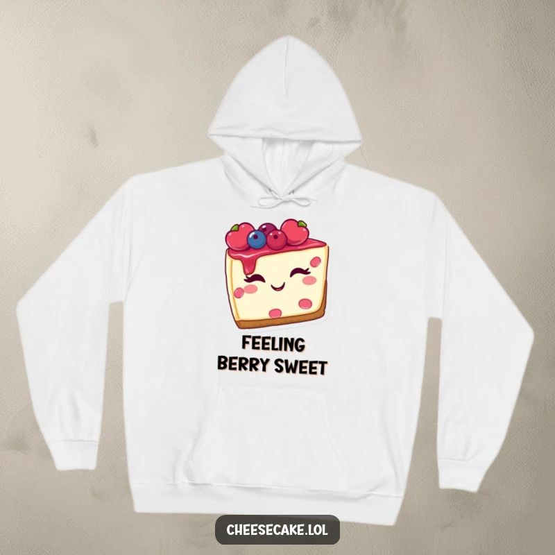 Funny hoodie featuring a slice of cheesecake with berries, winking playfully, perfect for cozying up with a treat.