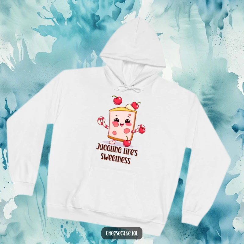 Funny hoodie featuring a smiling cheesecake slice juggling cherries with candy cane arms, perfect for cozy holiday fun.