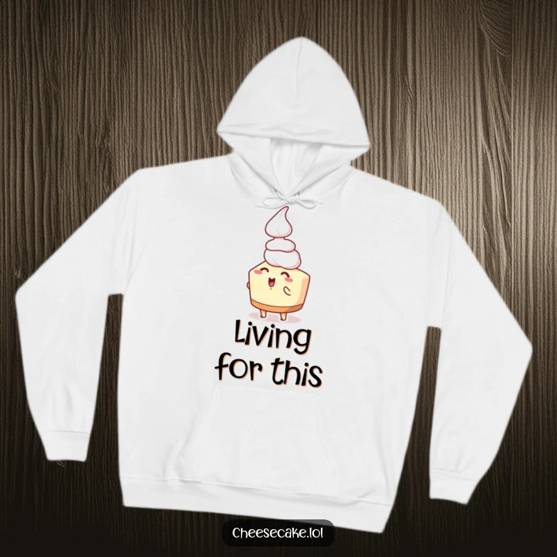 Funny cheesecake hoodie depicting an excited cheesecake character thrilled by a falling dollop of whipped cream, a cozy celebration of sweetness.