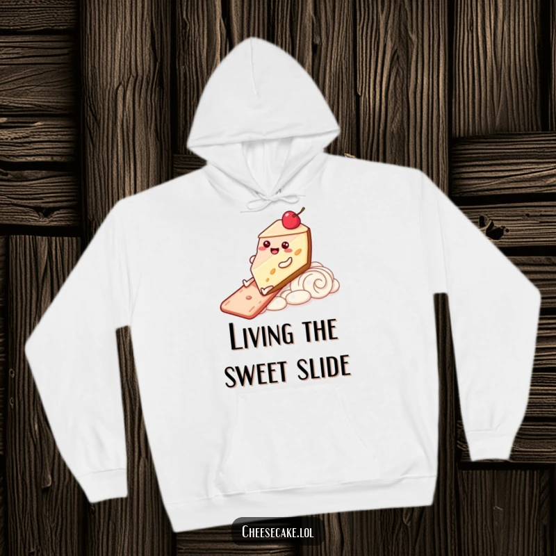 Funny Hoodie featuring a happy cheesecake character with legs sliding down a frosting slide, perfect for cozying up with joy.
